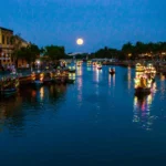 Best time lantern boat Hoi An with glowing lanterns on Thu Bon River at night