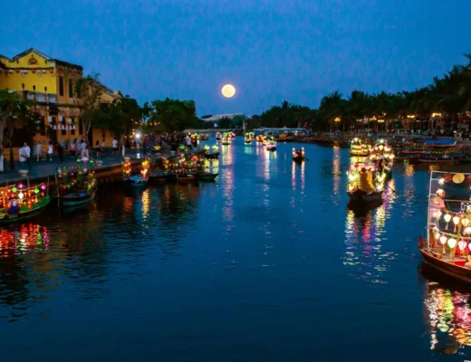 Best time lantern boat Hoi An with glowing lanterns on Thu Bon River at night