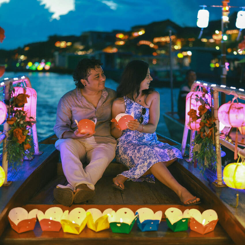 Taking photos on a lantern boat in Hoi An river at night