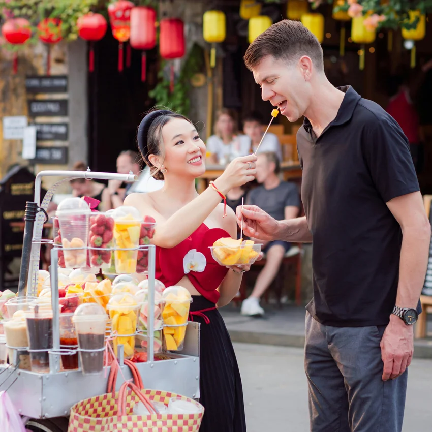 Budget traveler enjoying street food and walking in Hoi An Old Town